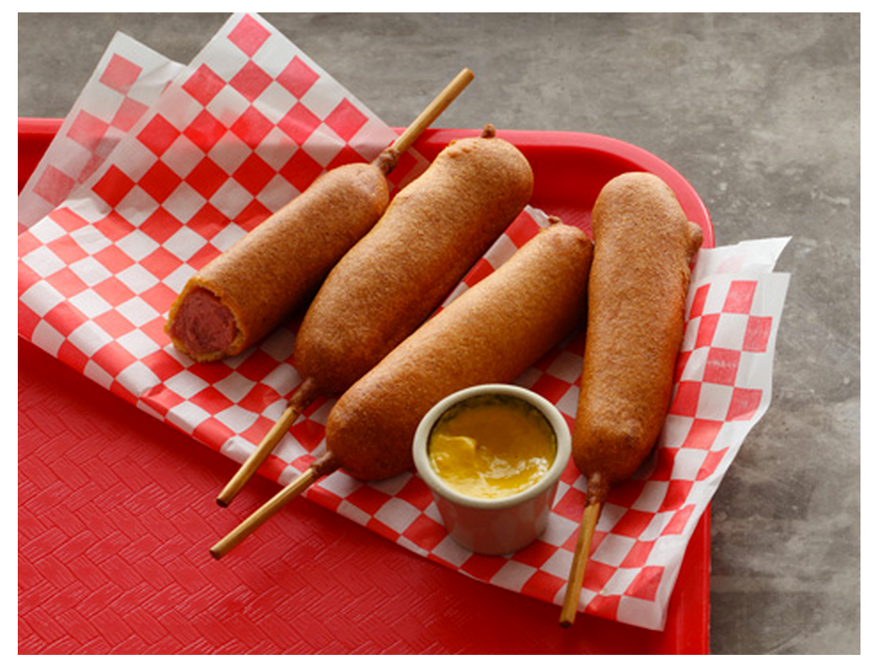 Corndogs with mustard on red plate