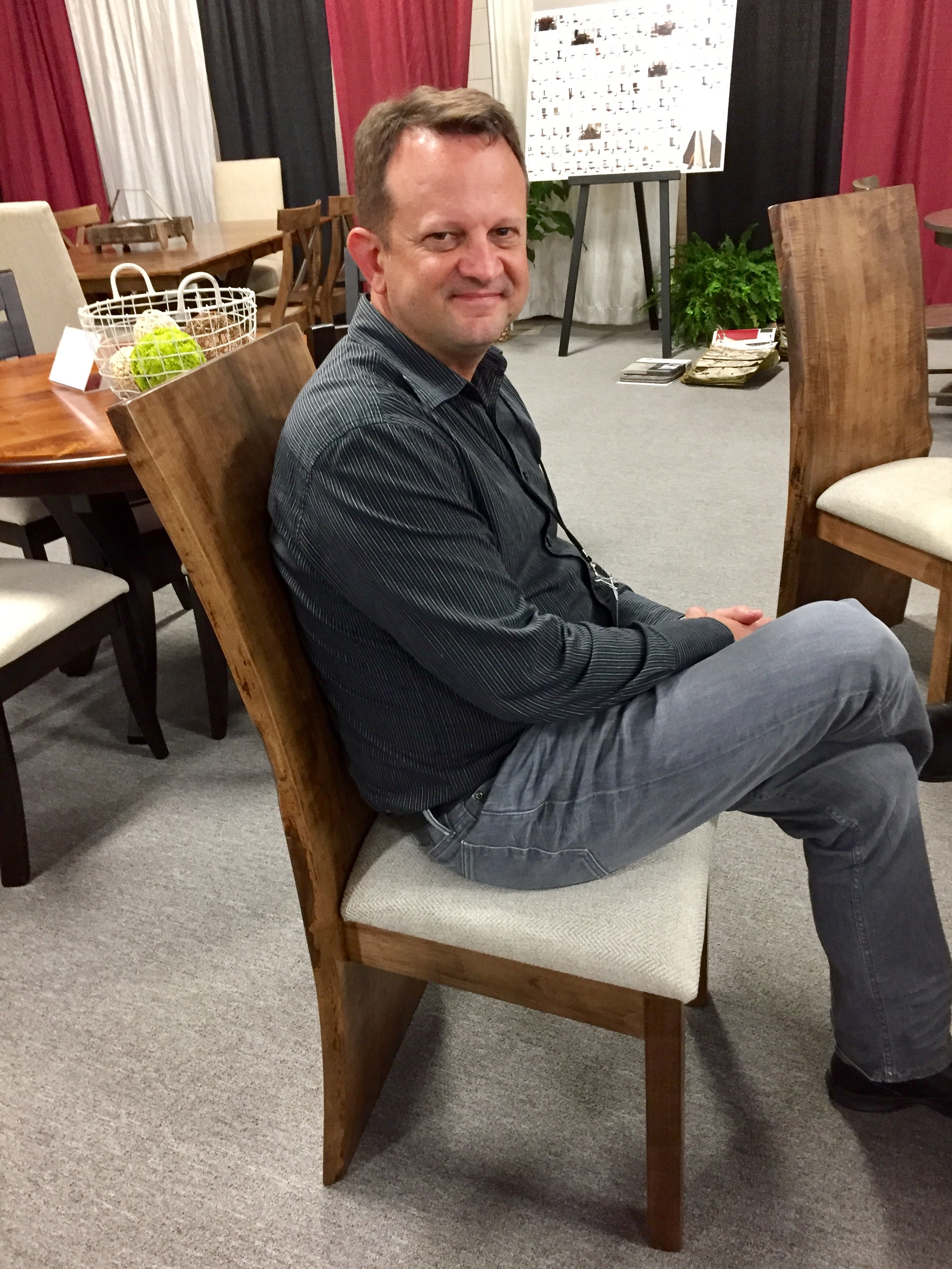 CEO Jim Miller testing out dining chairs