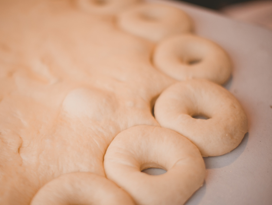 Doughnuts being cut from dough
