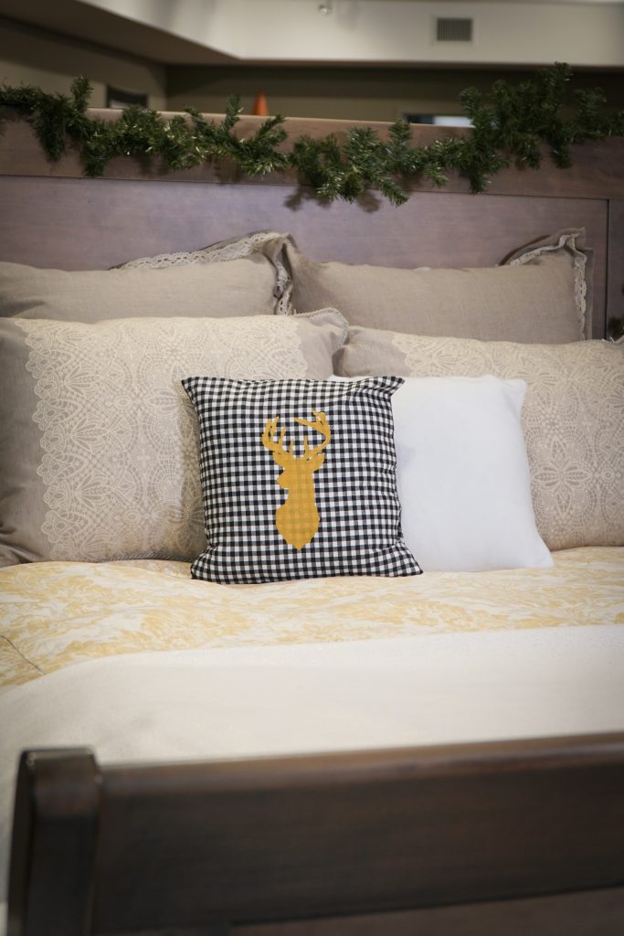 Transitions sleigh bed with garland and DIY pillow cases