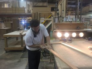 Hand sanding at MillCraft Woodshop.