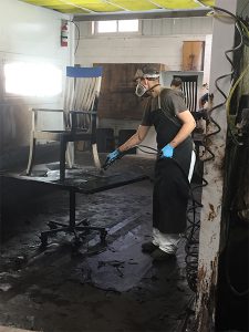 Applying stain at Shclabach Finishing Shop.