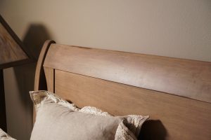 Light colored headboard with low sheen varnish.