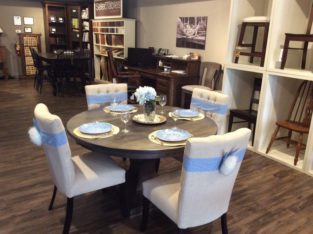 Wide view of bunny tail sashes on chairs around dining table