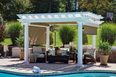 Amish Artisan Vinyl Pergola with shade curtains.