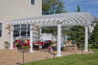 Amish Arcadian Vinyl Pergola on the side of a house.