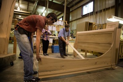 Working on a bed in an Amish woodshop