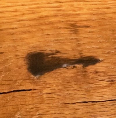Filled knot on barnwood table.