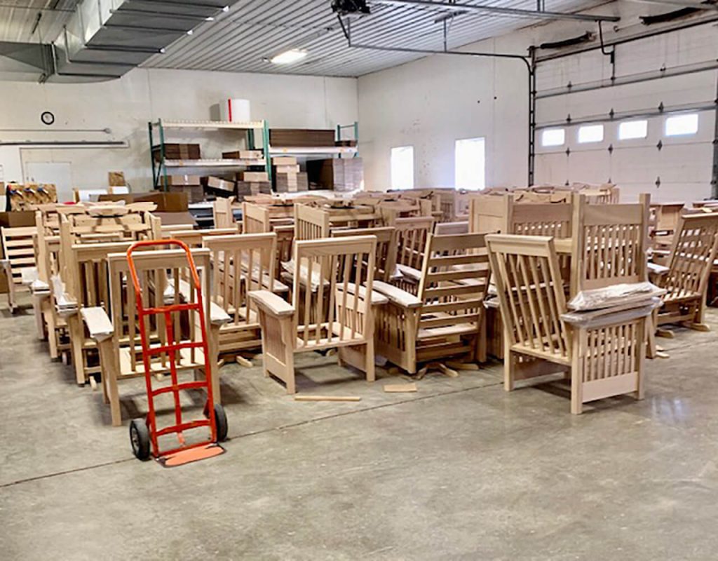 Solid wood chairs waiting for finish at an Amish wooshop.