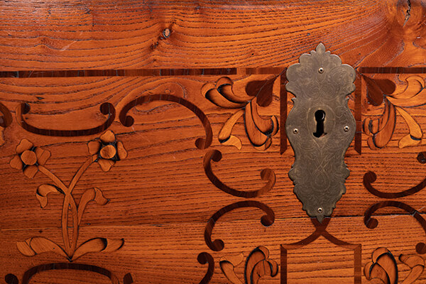 Closeup on elegant decorative wood inlays and a metal keyhole