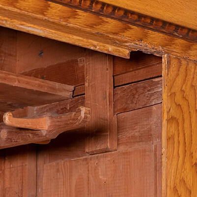 A close-up inside a wardrobe at Kauffman Museum shows a wedge-cleat joint