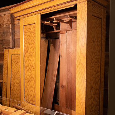 Medium wide shot of a wardrobe halfway disassembled at Kauffman Museum