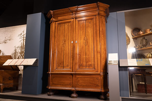 A tall antique wardrobe on display in Kauffman Museum in North Newton, KS
