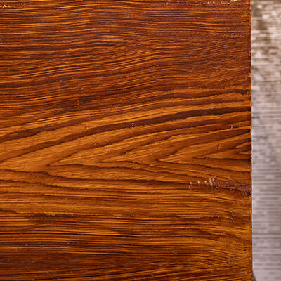 Close-up on a chest with faux wood grain painted on it, at Kauffman Museum