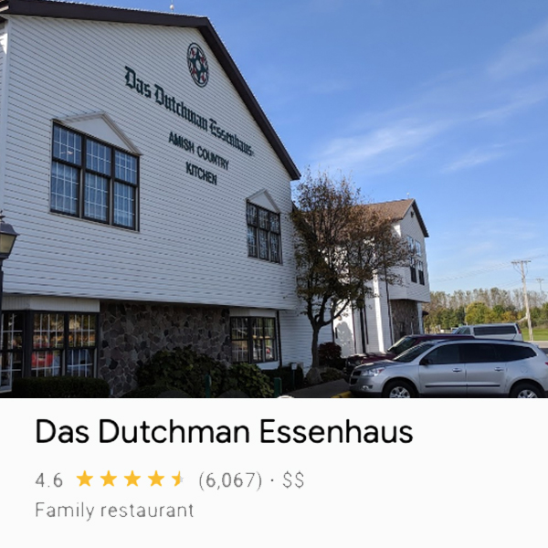 Front of Das Dutchman Essenhaus building from an angle with some cars parked in front