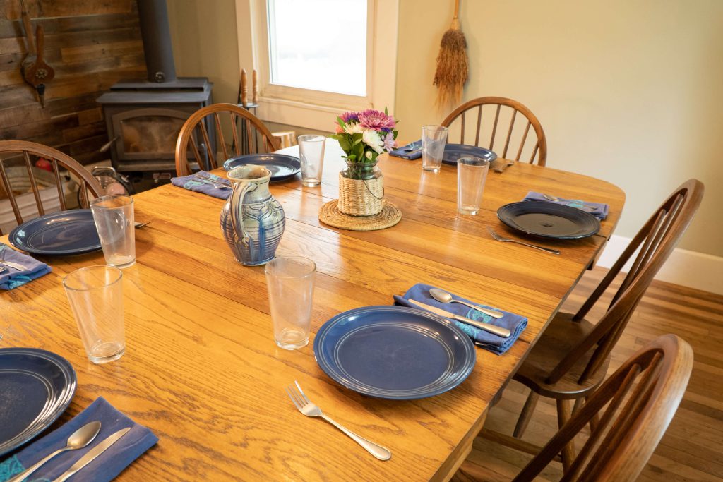 dining table set with dishes surrounded by DutchCrafters chairs