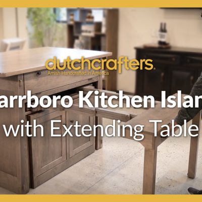 A stylish kitchen island with a dining table extending out of it and chairs topped with the title "DutchCrafters Carrboro Kitchen Island with Extending Table"