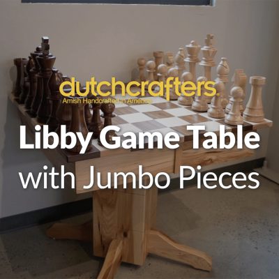 A solid wood game table is topped with the title, "DutchCrafters Libby Game Table with Jumbo Pieces"