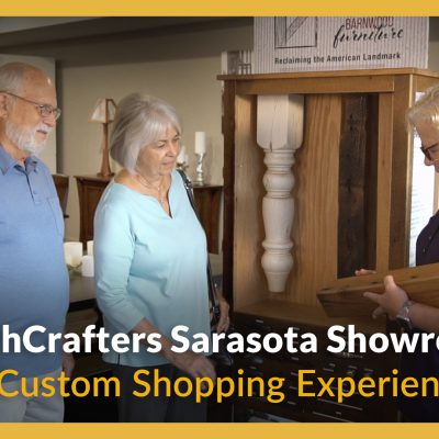 Image shows two shoppers viewing table legs with a furniture specialist, with the title, "DutchCrafters Sarasota Showroom: A Custom Shopping Experience"